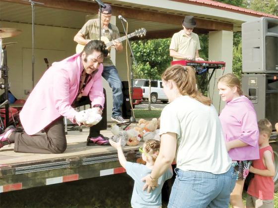 Elvis tribute artist Greg Burgess makes several young fans happy by handing out teddy bears during his performance of the King’s hit song “(Let Me Be Your) Teddy Bear” at last week’s Food Truck Tuesday event. The monthly food truck and live music events have been held at River Park the first Tuesday of each month since March. 