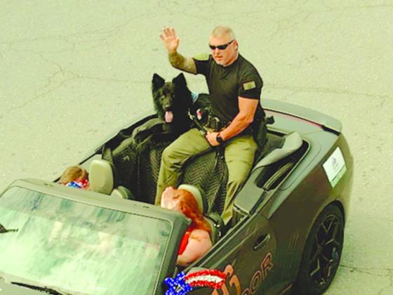 Honorary Grand Mashall K9 Arlo and his handler. (Photo by Robert Ferguson)