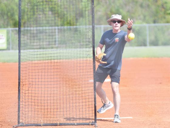 Gilmer County Fire Chief Daniel Kauffman throws the ceremonial first pitch.