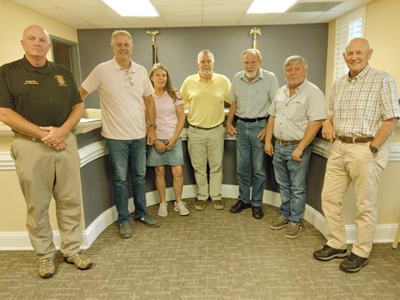 Retiring East Ellijay City Planner Mack Wood, center, is wished well on his retirement by, from left, Public Safety Director Larry Callahan, city councilmember Chris Callihan, city councilmember Linda Smith, city councilmember Ed Forrester, city councilmember James Waters and Mayor Don Callihan. 