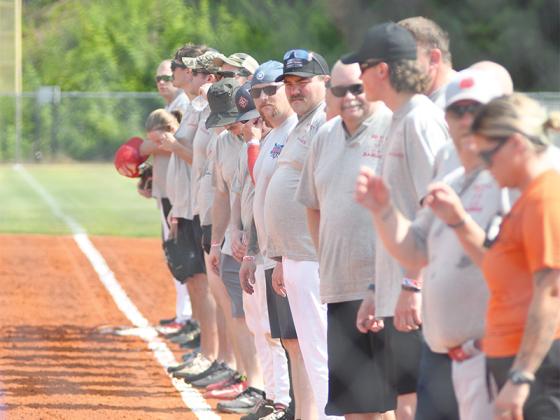 The firefighters team lines up during the Battle of the Badges charity softball tournament at the Clear Creek ball fields.