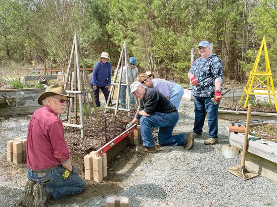 Above, Michael Harrison, Barry Broadwater, Wendy Bell, Cathy Broadwater, Carol Harris and Julia Padgett work to install slotted concrete blocks and new boards in the DIG’s raised beds. (Contributed photo)