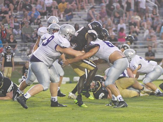 From left, Gilmer senior defensive linemen Bryson Fink and Bryson Shubin-Gibbs make a tackle for a loss versus Commerce last Friday.