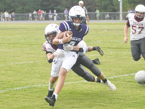 Clear Creek eighth-grade quarterback A.J. Callihan advances the offense toward the goal line versus Dawson County last Wednesday. He scored two touchdowns in the Cats’ 20-0 win.