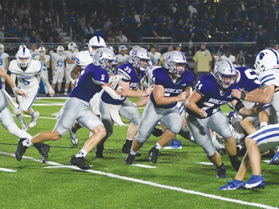 Gilmer High linemen Kyler Norton (74) and Blane Banks (54) and fullback Wyatt Stokes (35) lead the way for halfback Hunter Britain (5) versus Ringgold last week. Stokes finished with 153 rushing yards and Britain added 75 and a touchdown.