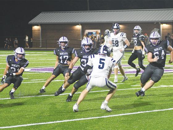 Gilmer High’s defense corrals a West Hall ball carrier, forcing him to reverse field last Friday. From left are, Bobcats Aspen Hataway (31), Bo Cronic (17), Peyton Chancey (33) and Blane Banks (54). Hataway was Gilmer’s top tackler on the night with 19, Chancey finished with 11, Cronic had nine and Banks made six stops. Hayden Morrison (12, in background) was there for eight total tackles. 