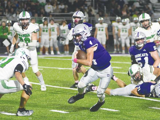 Gilmer High School junior quarterback Issac Rellinger makes his way through Pickens’ defense last Friday. Rellinger rushed for 90 yards and scored three touchdowns in the Bobcats’ 35-24 win. The victory snapped an eight-game winning streak for Pickens.