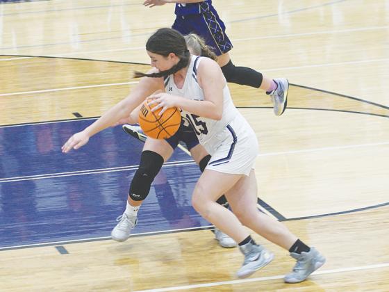 Maylee Bramlett drives to the basket in the seventh-grade game.