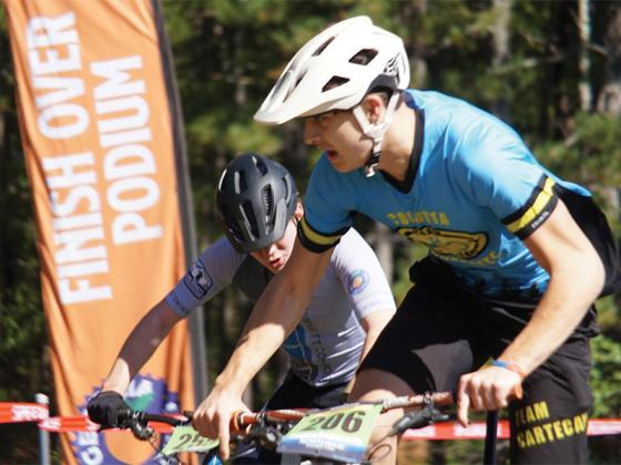Senior rider Jayden Calabretta outsprints his competition in the final turn at Dauset Trails.