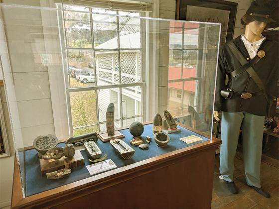 New items for the Tabor House Museum’s 2024 season include another entry in a continuing display of Civil War-era artillery shells, above, and digital picture frames, on exhibit case below, showing a variety of historical photographs.