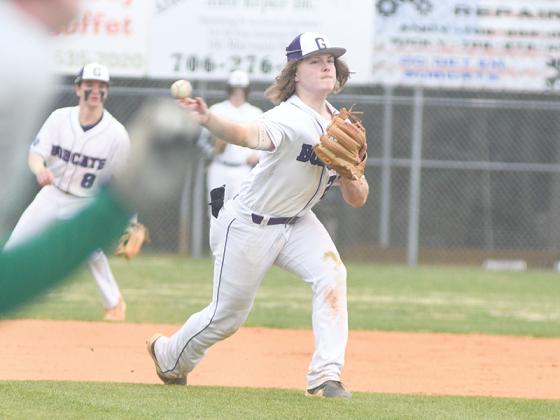 Gilmer High School third baseman Blake Grizzle throws to first for an out after fielding a ground ball versus Pickens. Offensively, Grizzle had five hits, which included a double and home run during the three-game series.