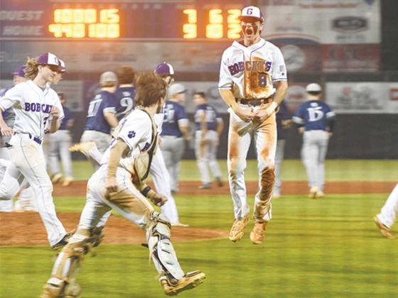 Gilmer’s Eli Cooper (8), catcher Hayden Berry and the Bobcats celebrate their state playoff clinching win over West Hall.