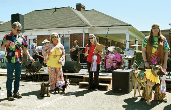 FOGAS President Sylvia Harris, third from left, announces entrants in the Grooviest Costume contest.