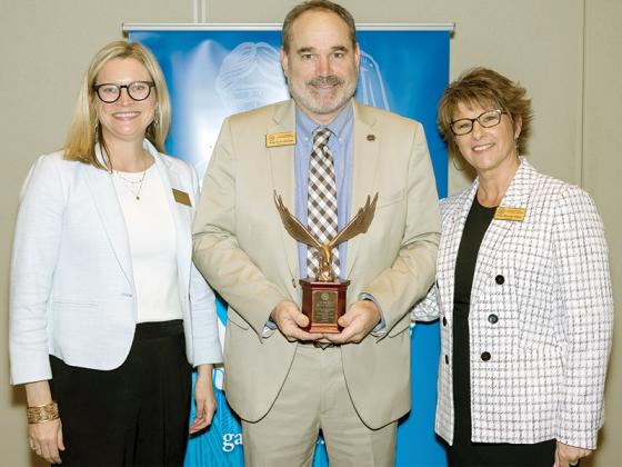 Gilmer County Probate Judge Scott Chastain, center, receives the Outstanding Probate Judge Award from Coweta County Probate Judge Carrie Markham, left, and Judge Danielle McRae, Council of Probate Court Judges of Georgia president, right.