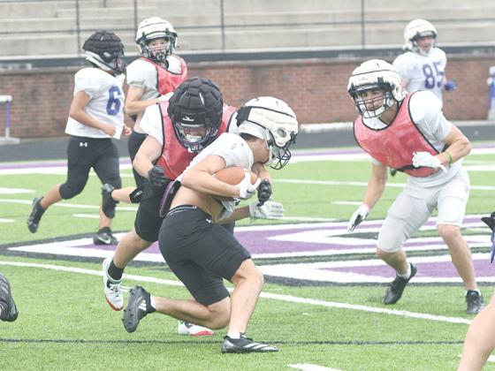 Gilmer High finished spring football practice last Wednesday with an intrasquad scrimmage. Peyton Chancey lowers his shoulder to make a tackle as fellow linebacker Memphis Lewallen closes in to assist. 