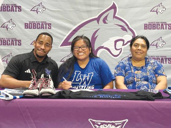 Gilmer High’s Linda Tercero, seated center, will attend Lindsey Wilson College, Ky., and wrestle for the Blue Raiders. Joining Tercero from left are, Lindsey Wilson womens head coach Devane Dodgens and mom Maria Perez.