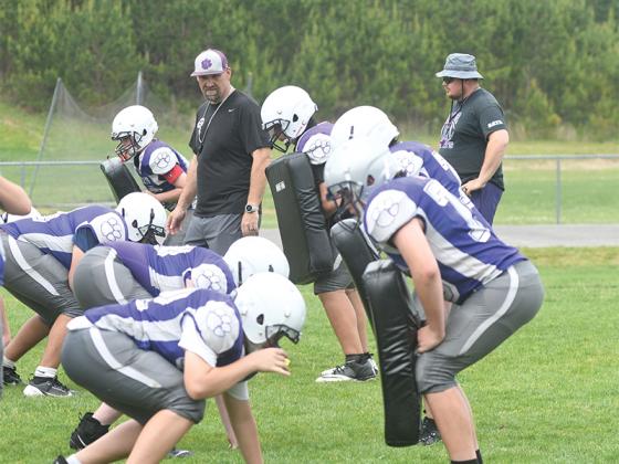 Defensive coordinator Matt Banks and assistant Cole Farist oversee linemen drills.