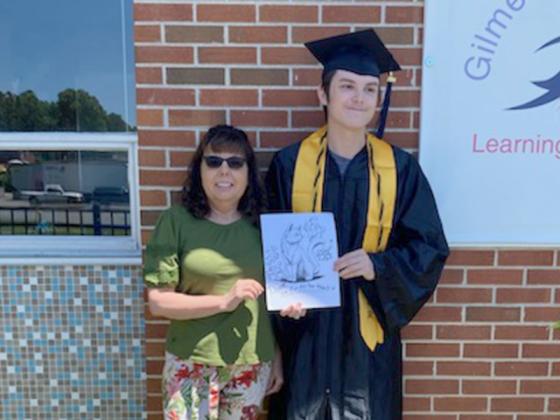 Recent GED graduate Drake Sanborn holds some of his artwork with his mentor at the Gilmer Learning Center, senior teacher Dita Paukert. (Contributed photo)
