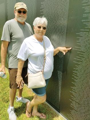 With the help of American Legion Post 82 Auxiliary members, Jerry and Sue Hughes Nunn, of Acworth, found the name of Army Sgt. Larry Davis on the Vietnam Traveling Memorial Wall. As Sue Hughes, she and a couple of other friends were with Davis the night before he shipped out to Vietnam. The Wall was in Ellijay for five days of viewing before being taken to its next stop on Tuesday. (Photo by Mark Millican)