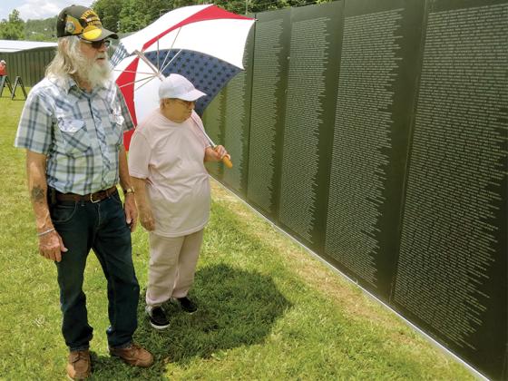 Gilmer County residents Jerry and Ilene Petit view the American Veterans Traveling Tribute Vietnam Memorial wall, which was at the Ellijay Lions Club fairgrounds from June 20-24. Jerry served in Germany during the Vietnam War as military police at a post where ammunition was made. The public could visit the traveling wall, an 80-percent size replica of the Washington D.C. memorial, 24 hours a day. It was brought here by the Ira Cochran American Legion Riders. (Photo by Michael Andrews/Mountain Life Editor)