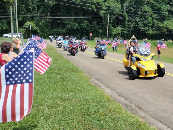 Dozens of motorcyclists and other citizens waving American flags welcomed the Vietnam Traveling Memorial Wall to the Lions Club Fairgrounds just before noon Wednesday. The Wall was assembled and opened for viewing Thursday, June 20, and was in place through Monday, June 24, 24 hours a day. Security and grief counselors were on site at 1729 S. Main St. at all times. (Photo by Mark Millican)
