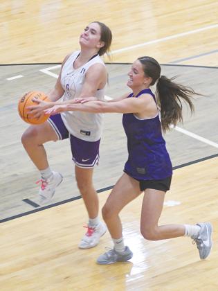Rising junior Bree Burnette is fouled by sister Beth Burnette in the first quarter of the Lady Cats’ alumni basketball game.