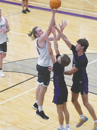 GHS Bobcats Cooper Farmer and Mack Kiser defend the post in overtime to keep Cade Carter from scoring.