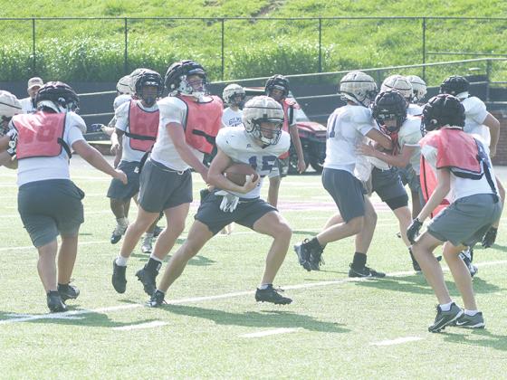 Gilmer High’s Kyle Cowart makes his way through the defense at Monday’s practice.