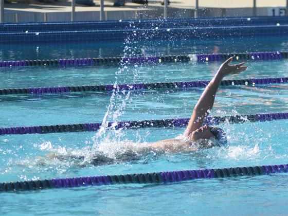 Jacob Watson (above) competes in the backstroke.