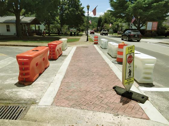 Recent changes to the traffic environment of downtown Ellijay include a no parking zone extending from North Avenue to the roundabout, below, and barricades to allow for curing of a newly poured crosswalk, above.