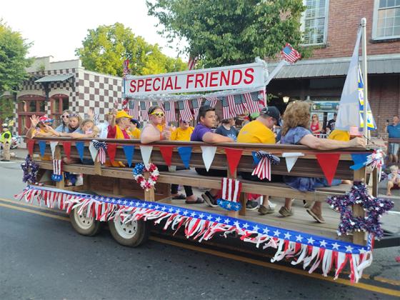 The perennial Special Friends ride in style on the Ellijay Lions Club float during the Independence Day parade. (Photo by Mark Millican)