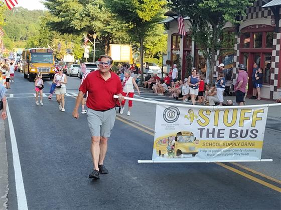 Gilmer County Optimist Club members put the spotlight on their annual ‘Stuff the Bus’ drive to collect school supplies for children. (Photo by Mark Millican)