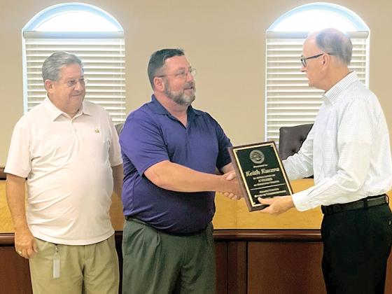 Gilmer County Post Commissioners John Marshall (left) and Hubert Parker (right) present outgoing Emergency Management Director Keith Kucera with a plaque commemorating his service. Kucera is joining the Gilmer County School System as an instructor. (Photo by Alyssa Ashurst)