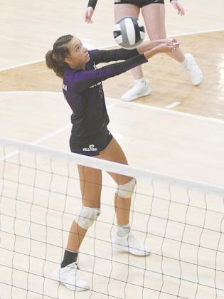 Gilmer senior Madison Bradshaw keeps a rally alive last Tuesday versus Woodland.