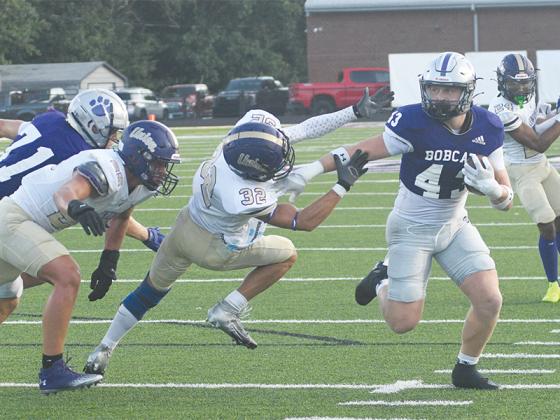 Gilmer sophomore Douglas Callihan discards Union County’s Darin Patterson on his first of two touchdown runs last Friday. 