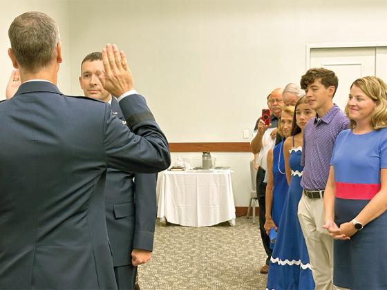 Russell Gheesling, a graduate of the Gilmer High School Class of 1999, is promoted to the rank of colonel in the U.S. Air Force by Brigadier General Nathan Owendoff at Hurlburt Field in Fort Walton Beach, Fla., on Aug. 1. Gheesling’s family members stand at right. (Photo by Sid Webb)