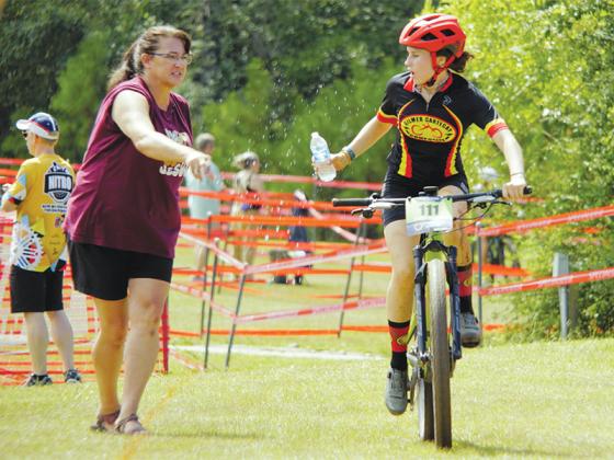 Team Cartecay’s Isabella Cianciolo takes water in the feed zone