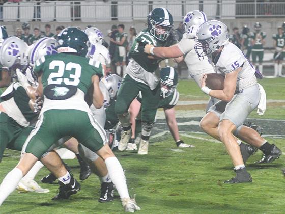 Gilmer High senior Kyle Cowart (15) gets a block from Sam Jones (51) last Friday at Westminster. Cowart finished with 60 yards on six carries. 