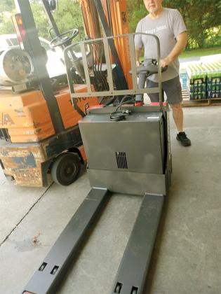 Gilmer Community Food Pantry warehouse manager Tim Prater with the facility’s new motorized pallet jack.