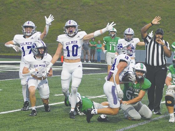 From left, Gilmer’s Bo Cronic, Hunter Britain, Grant Ballew and Kyle Cowart signal that it is the Bobcats’ ball after Memphis Lewallen’s (18) fumble recovery versus Pickens Aug. 30. GHS travels to Westminster Friday for a 7:30 p.m. kickoff.