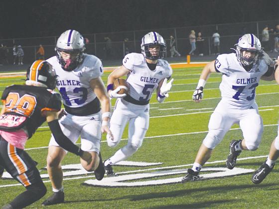 Above, Bobcats Douglas Callihan (43) and Logan Hightower (73) lead the way for Hunter Britain (5) last Friday versus LaFayette. Britain racked up 190 rushing yards on just seven carries and scored one touchdown in Gilmer’s 48-7 win.