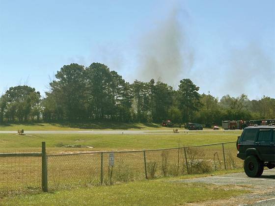 Smoke rises from a small plane crash at the Gilmer County airport.