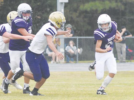 Clear Creek’s Silas West looks for running room around the edge, and he and the Bobcats will host Fannin County today to begin the playoffs.