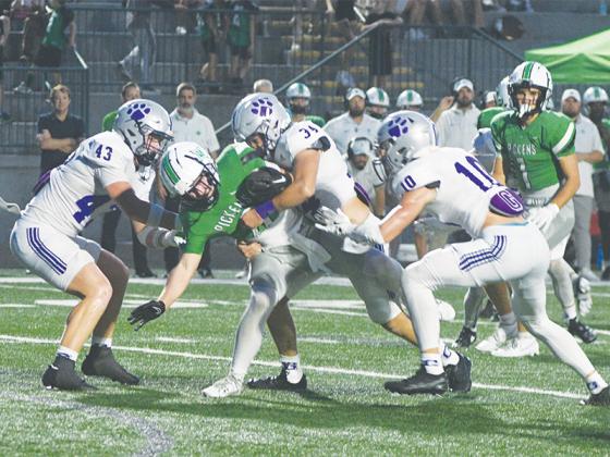 From left, Gilmer High’s Douglas Callihan, Peyton Chancey and Grant Ballew team up for a tackle against Pickens. 