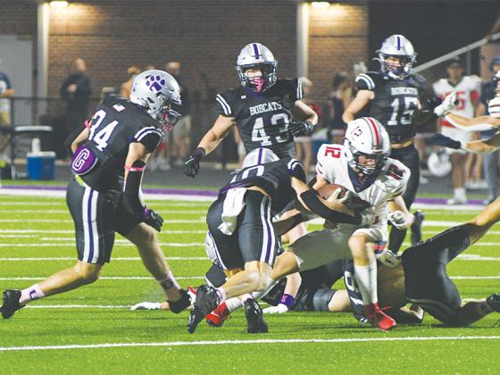 Bobcat seniors Grant Ballew (10) and Memphis Lewallen (18) tackle Heritage’s Logan Cheatwood as teammates Peyton Chancey (34), Jett Burrell, Douglas Callihan (43) and Kyle Cowart (15) close in.