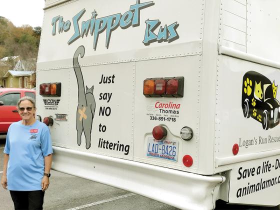 Sylvia Harris, the president of Friends of Gilmer Animal Shelter, stands by the Snippet Bus during its recent stop in Ellijay on Veterans Day. (Photo by Mark Millican)