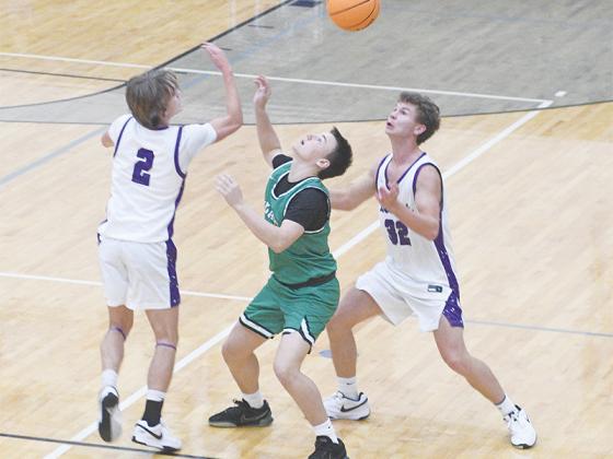 Gilmer senior Cooper Farmer (2) swats the ball loose as teammate Boston Teague (32) helps apply pressure during the Bobcats’ press versus Murray County last Thursday.