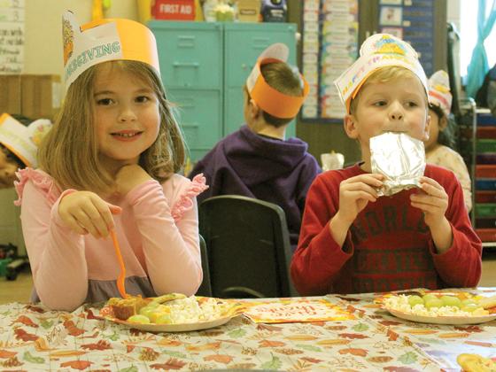 Brentlee Crump and Peter Kowalczyk display their hats while eating in in Courtney Hyatt’s class.
