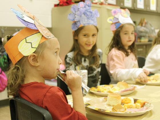 Clear Creek Elementary School kindergarteners Ayda Jones, April Picon Wells and Katelyn Cruse enjoy a holiday snack in their turkey hats during their last day in Kalin Zagarola’s class before the Thanksgiving holidays. 