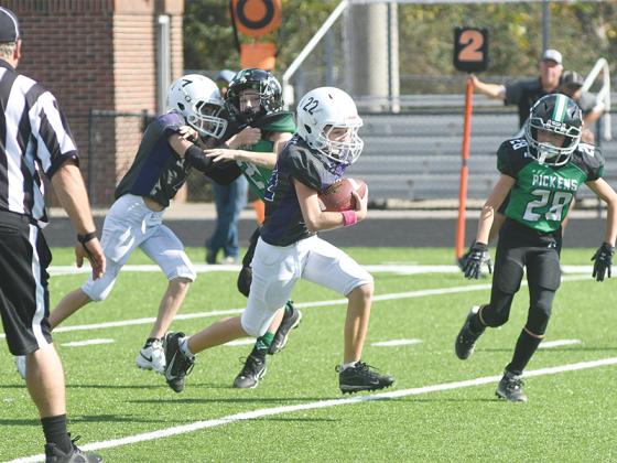 Gilmer’s Lance West (22) breaks a long run through the middle of Pickens’ defense in the fifth-grade Bobcats’ 33-0 victory.